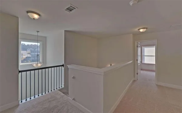a view of a hallway with windows