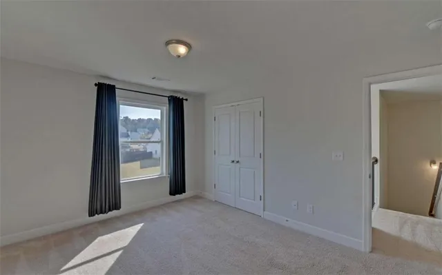 a bathroom with a granite countertop sink a light fixture and a mirror