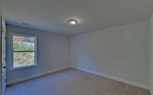 a view of an empty room and wooden floor