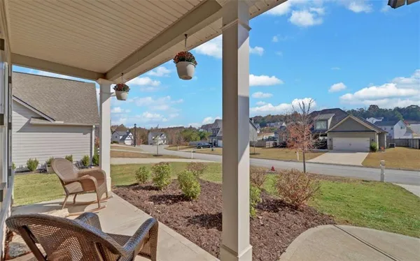 a view of a patio with a table chairs potted plants and palm tree