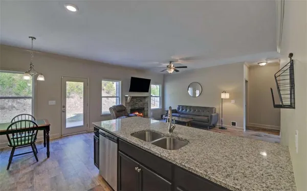 a kitchen with granite countertop a sink and a stove top oven
