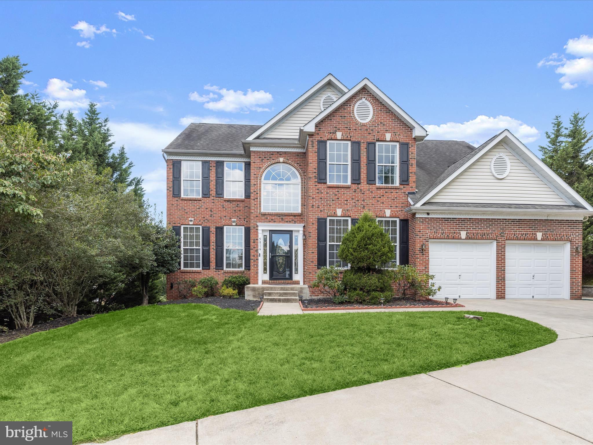 5816 Rockburn Woods Way Elkridge, MD 21075 - Photo 1 of 64 a front view of a house with a yard and potted plants