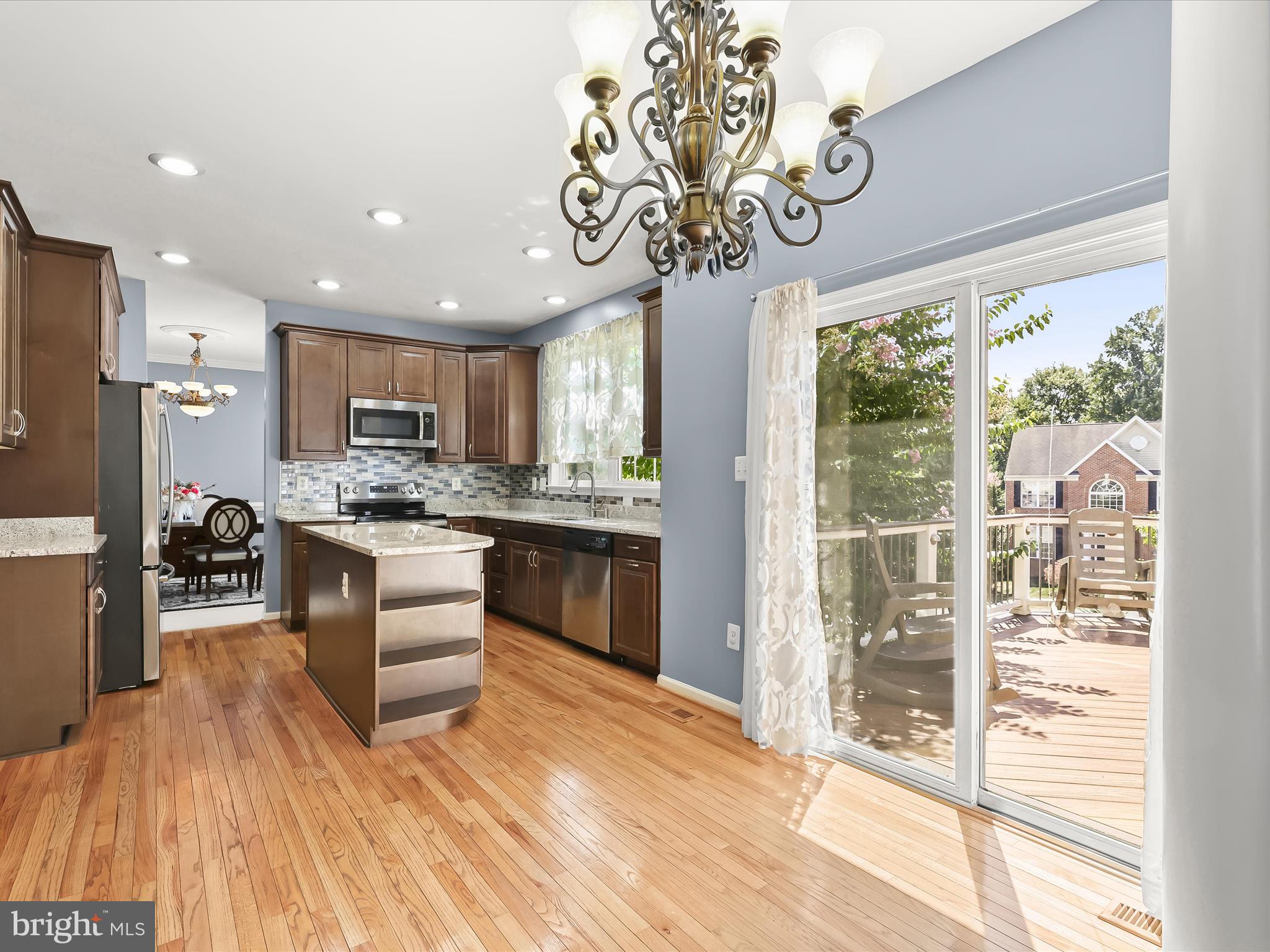 5816 Rockburn Woods Way Elkridge, MD 21075 - Photo 16 of 64 a kitchen with stainless steel appliances granite countertop a refrigerator a sink dishwasher a oven with white cabinets and wooden floor