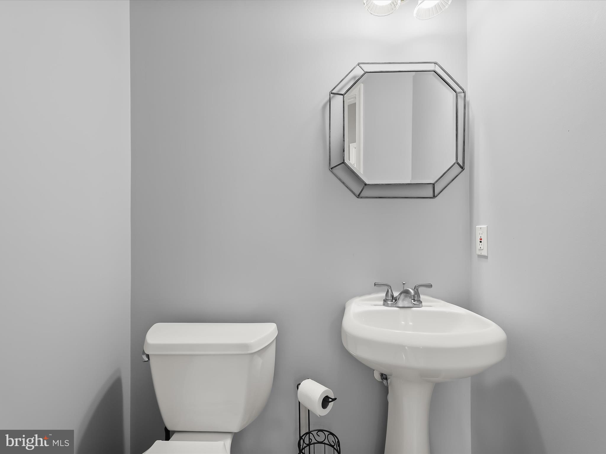 5816 Rockburn Woods Way Elkridge, MD 21075 - Photo 25 of 64 a bathroom with a toilet sink and mirror