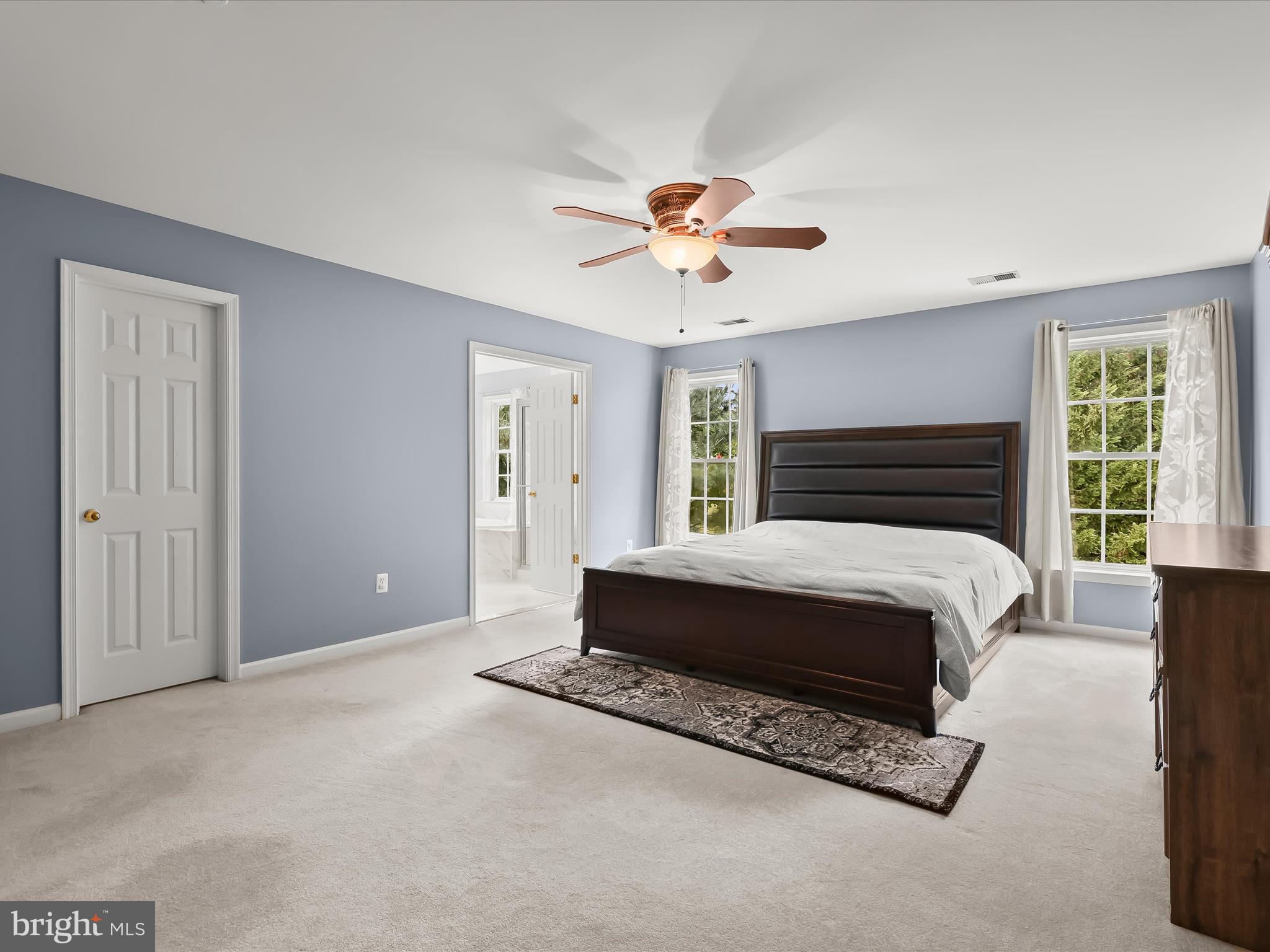 5816 Rockburn Woods Way Elkridge, MD 21075 - Photo 29 of 64 a spacious bedroom with a bed and a chandelier