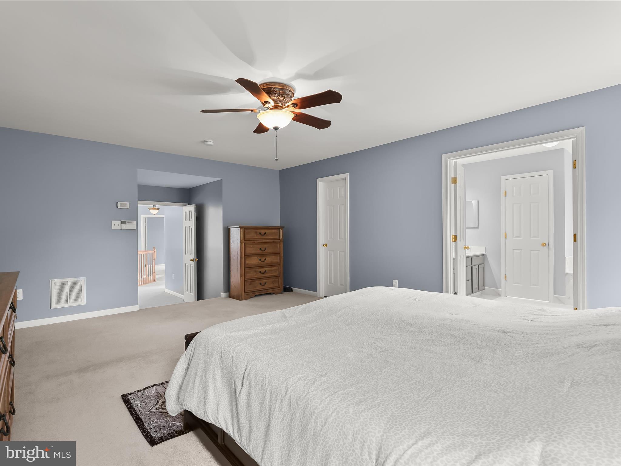 5816 Rockburn Woods Way Elkridge, MD 21075 - Photo 30 of 64 a bedroom with a large bed and a chandelier