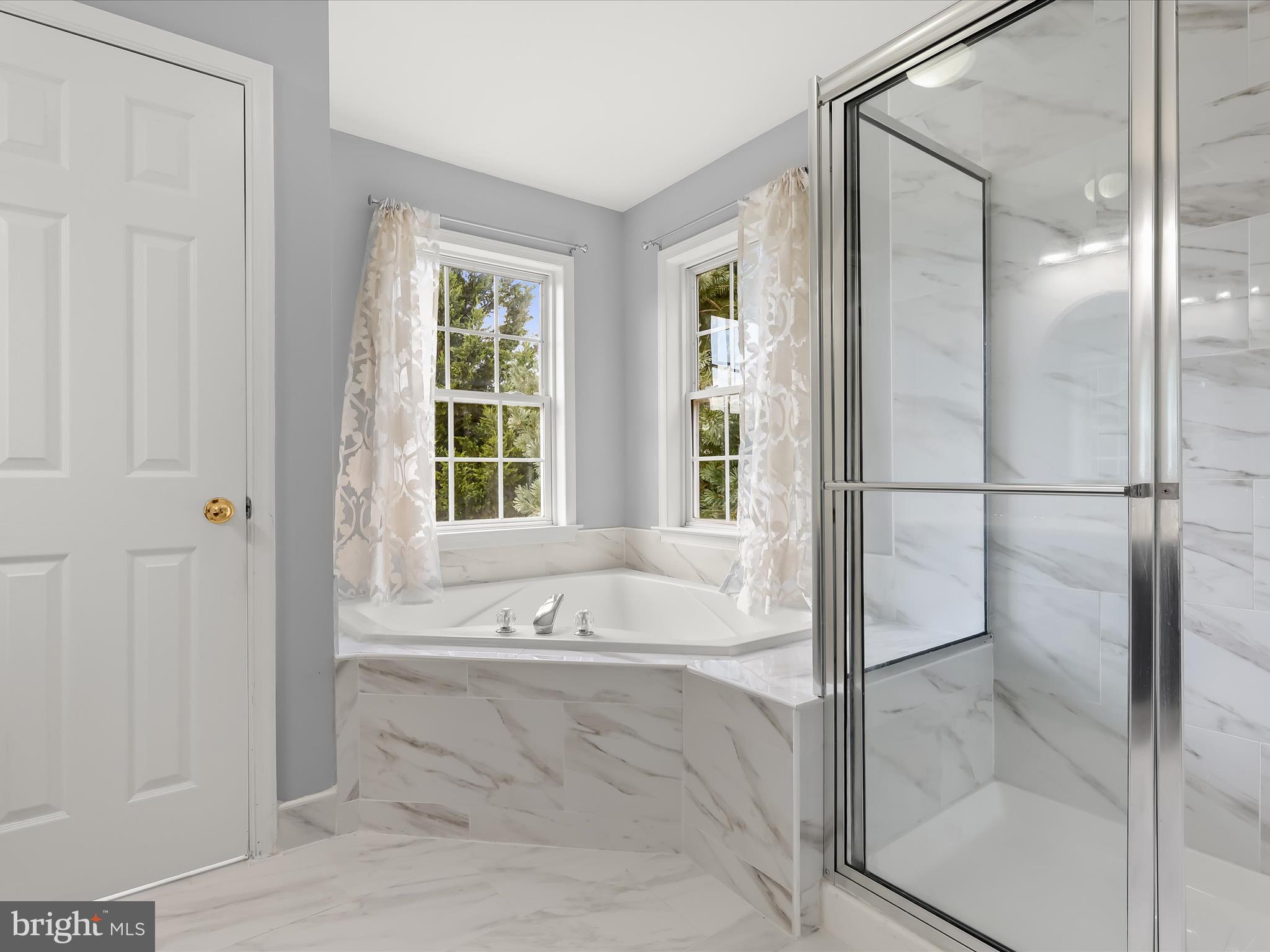 5816 Rockburn Woods Way Elkridge, MD 21075 - Photo 34 of 64 a spacious bathroom with a bathtub and a shower