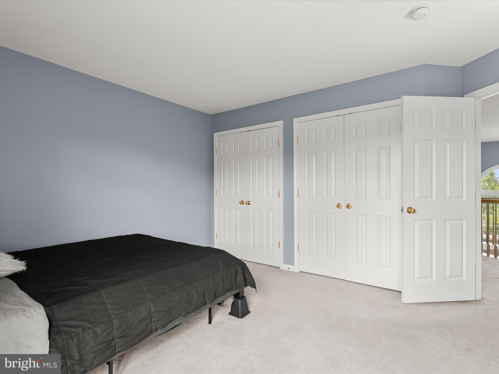 5816 Rockburn Woods Way Elkridge, MD 21075 - Photo 39 of 64 a bedroom with a bed and a cabinets