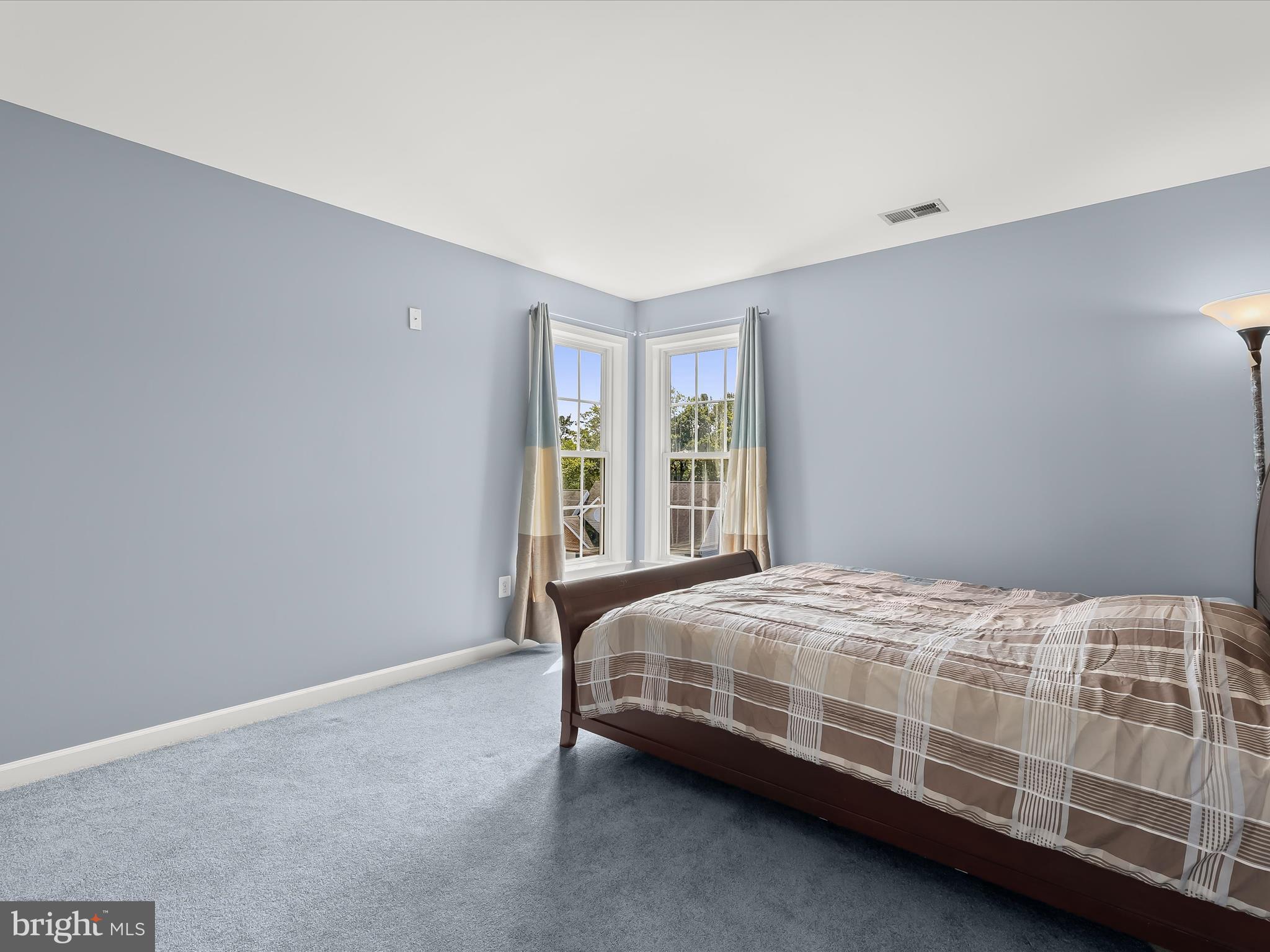 5816 Rockburn Woods Way Elkridge, MD 21075 - Photo 43 of 64 a bedroom with a bed lamp and a window