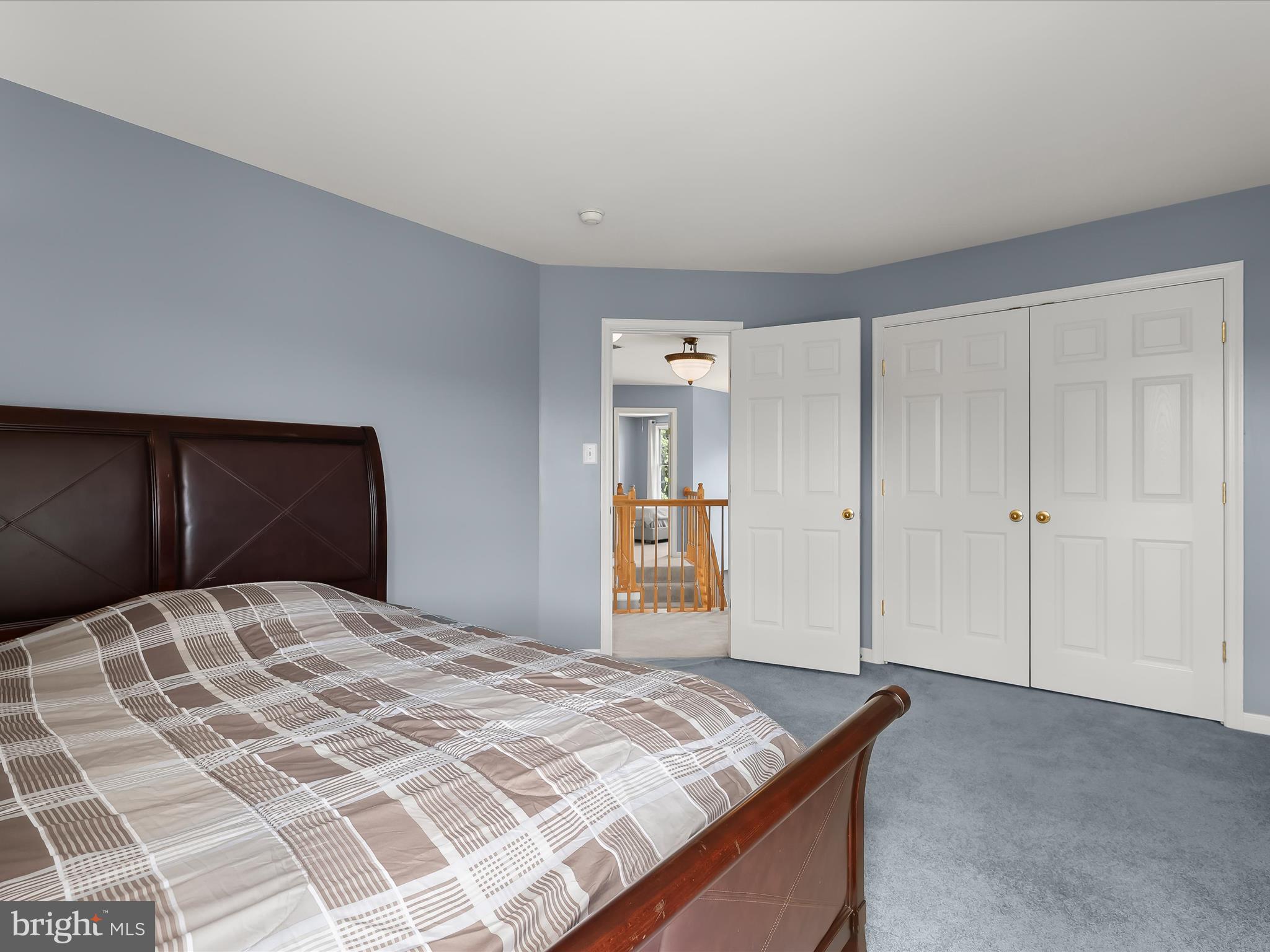 5816 Rockburn Woods Way Elkridge, MD 21075 - Photo 44 of 64 a bedroom with a bed and a cabinets