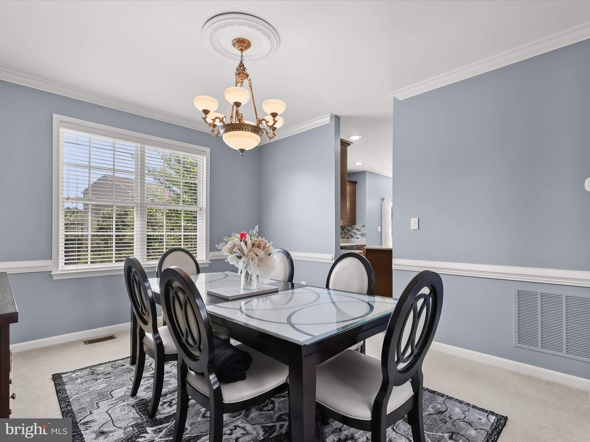 5816 Rockburn Woods Way Elkridge, MD 21075 - Photo 7 of 64 a view of a dining room with furniture window and wooden floor
