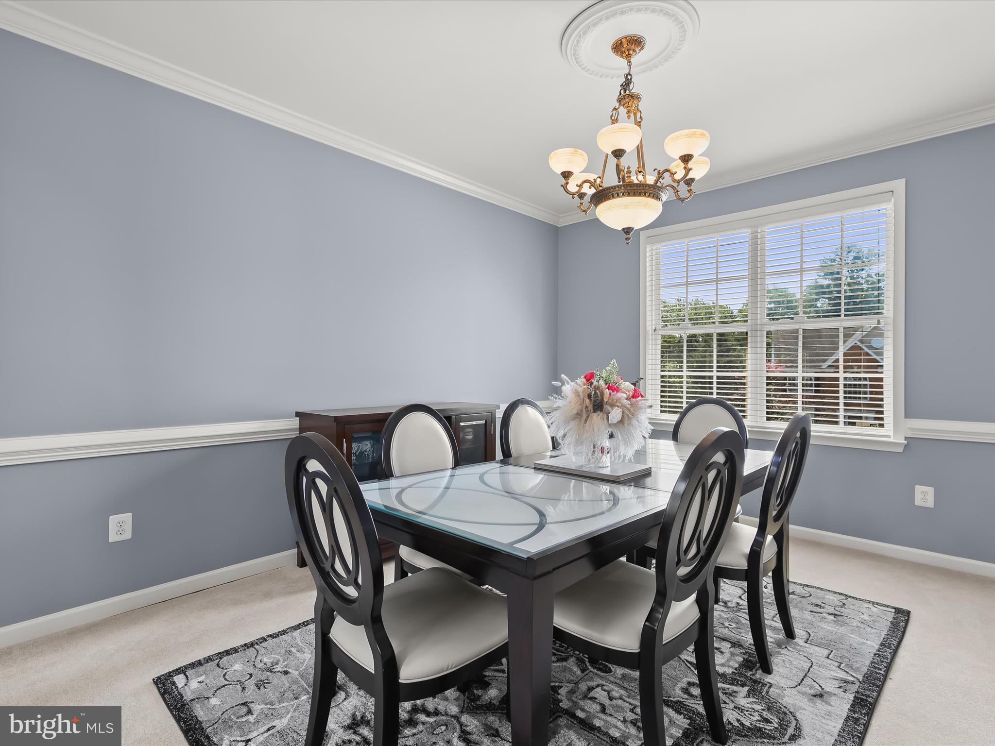 5816 Rockburn Woods Way Elkridge, MD 21075 - Photo 8 of 64 a view of a dining room with furniture a chandelier and wooden floor