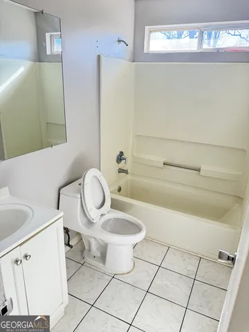 a bathroom with a toilet and a sink