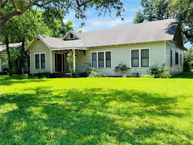 a front view of a house with a yard and porch