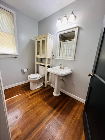 a bathroom with a sink toilet and mirror