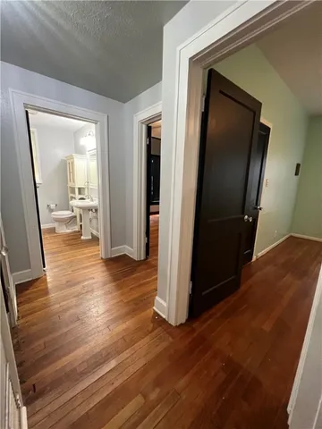 a view of a hallway view with wooden floor and staircase