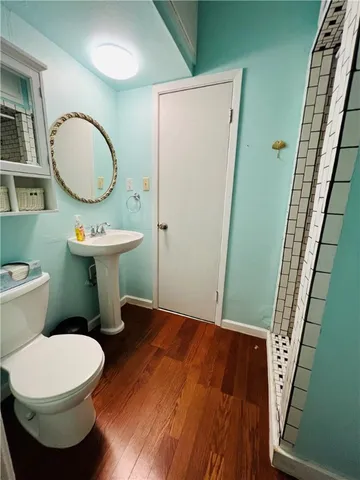 a bathroom with a toilet a sink and a mirror