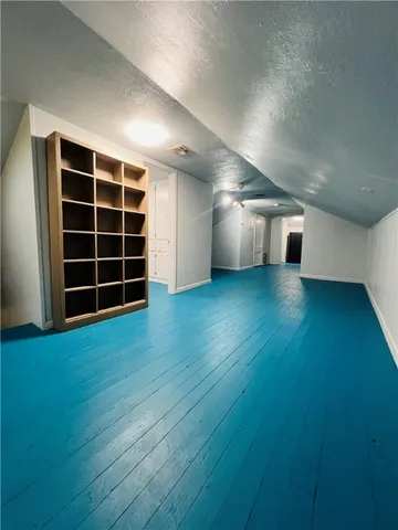 a view of a room with wooden floor and windows