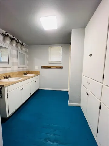 a kitchen with white cabinets and white appliances