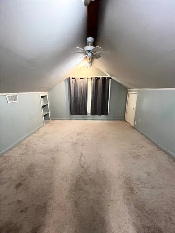 a view of a livingroom with a ceiling fan and hardwood