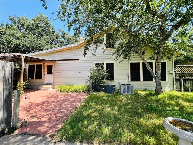 a front view of house with yard and green space