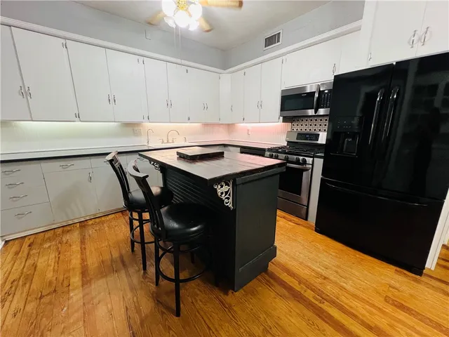 a kitchen with stainless steel appliances a stove a sink dishwasher and a refrigerator