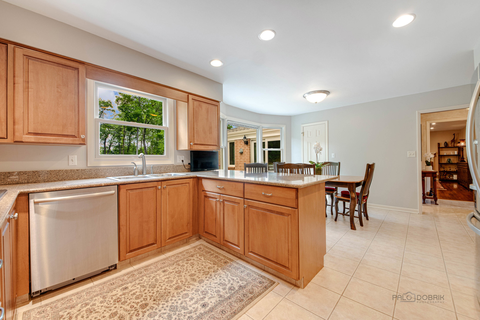 80 North Ridge Road Lake Forest, IL 60045 - Photo 11 of 36 a kitchen with stainless steel appliances granite countertop a table and chairs in it