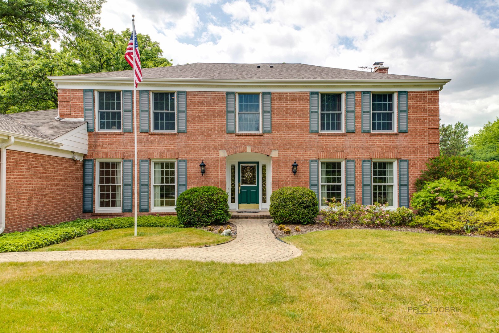 80 North Ridge Road Lake Forest, IL 60045 - Photo 2 of 36 a front view of a house with garden