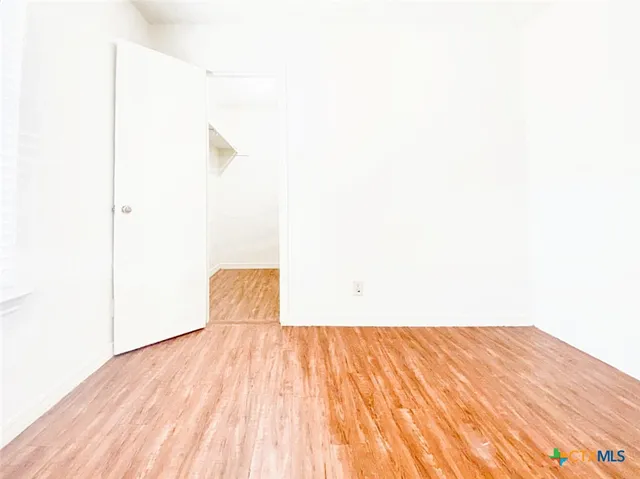 a view of a room with wooden floor