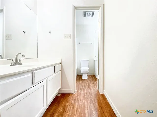a spacious bathroom with a sink and a mirror