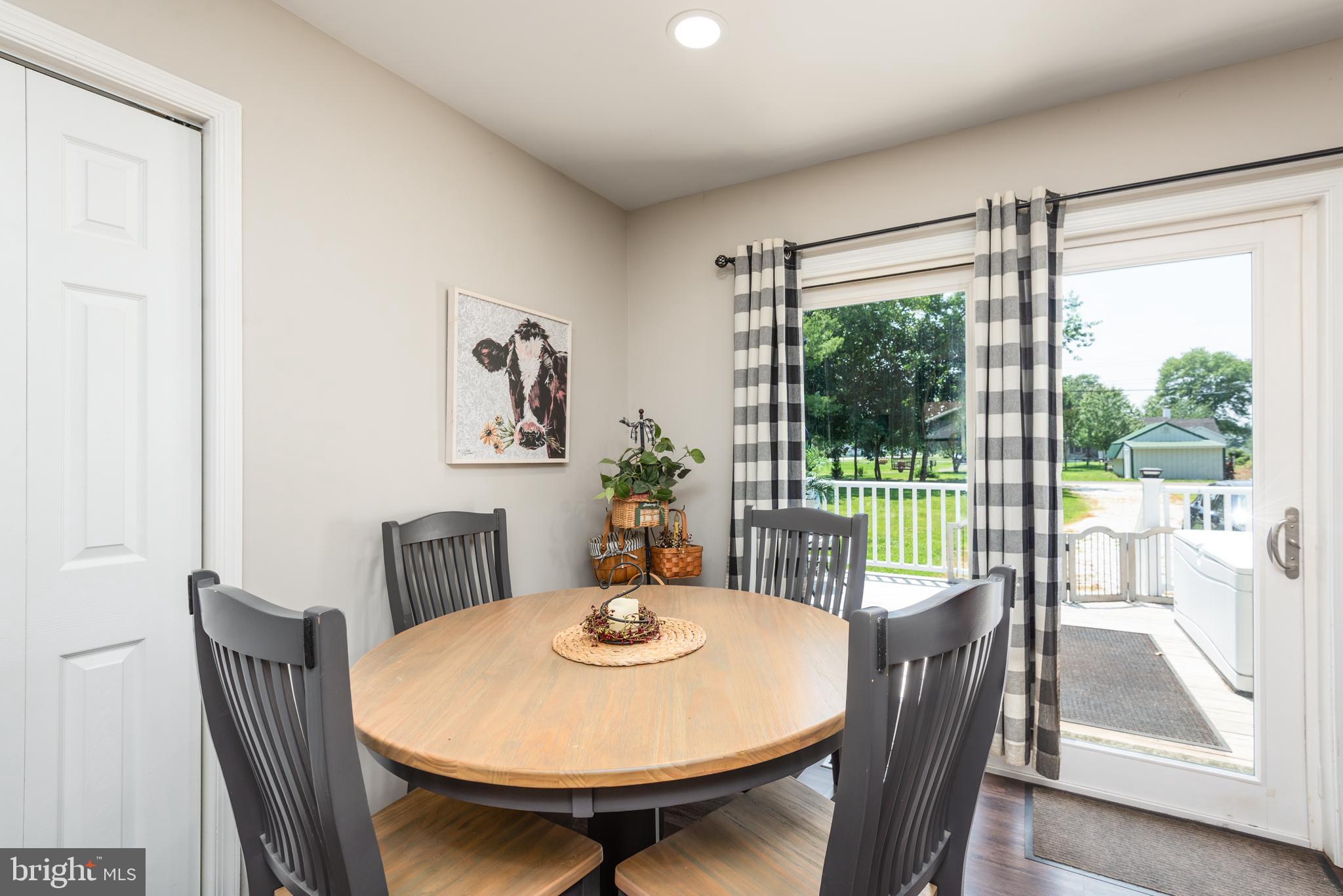 505 Maryland Avenue Ridgely, MD 21660 - Photo 11 of 23 a view of a dining room with furniture wooden floor and a potted plant