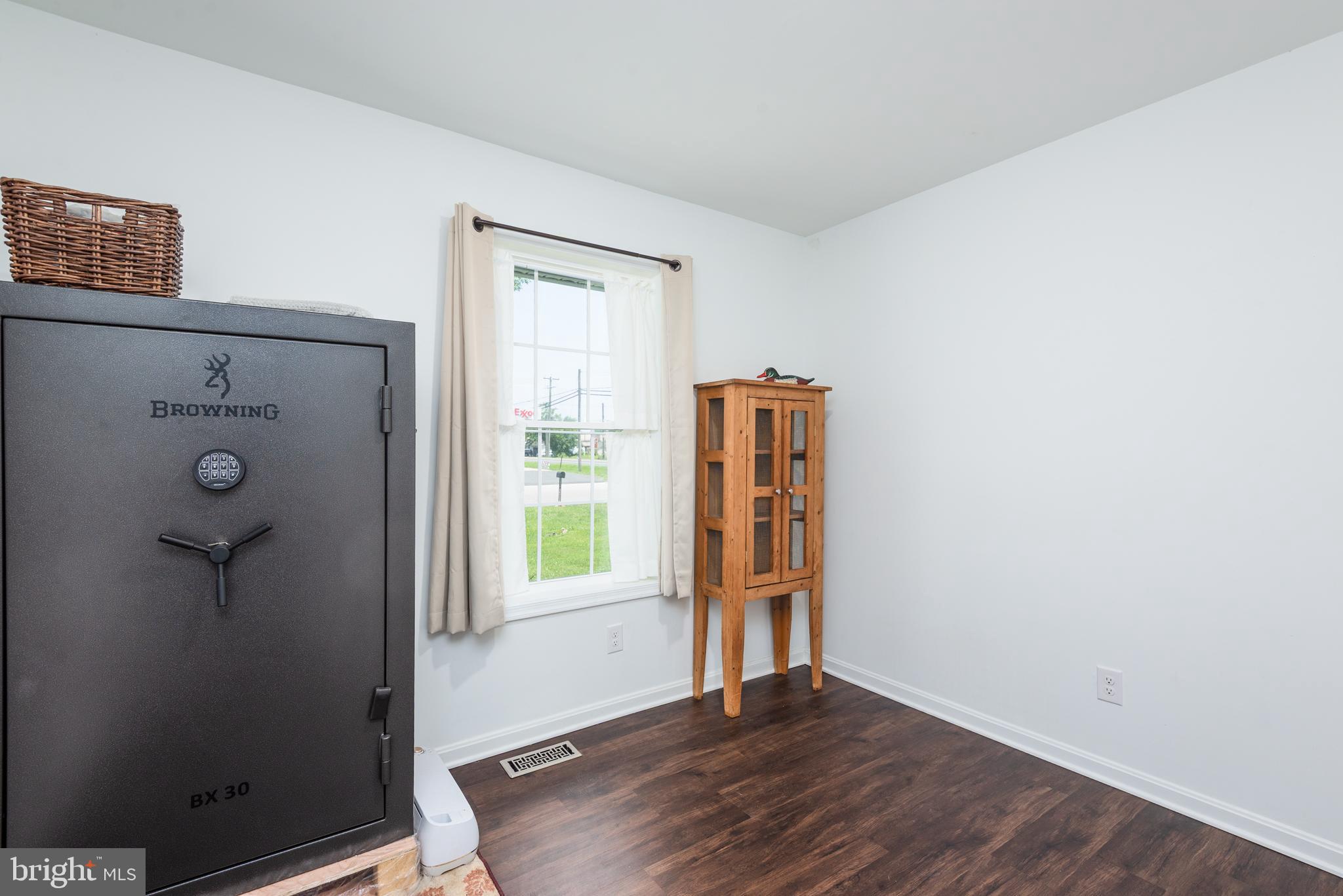 505 Maryland Avenue Ridgely, MD 21660 - Photo 17 of 23 a view of an empty room with wooden floor and a window