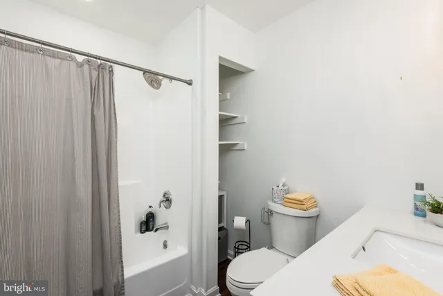 a white toilet sitting next to a bathroom sink