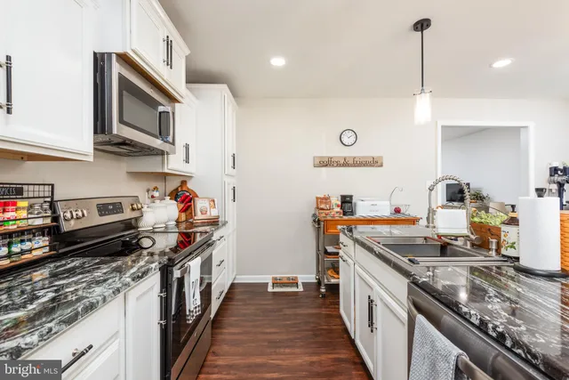 a kitchen with stainless steel appliances granite countertop a stove and a sink