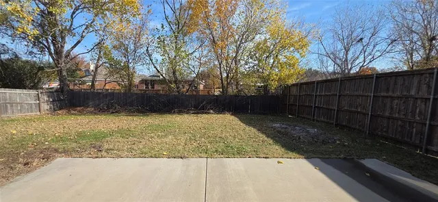 a view of backyard with large trees