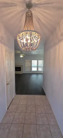 an empty room with a fireplace and wooden floor