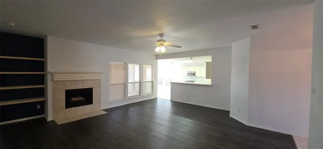a view of empty room with a fireplace