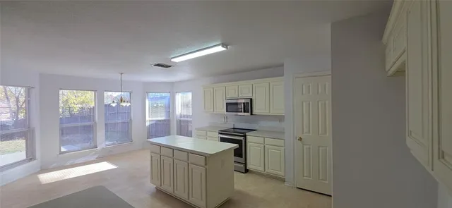 a kitchen view with a refrigerator and microwave
