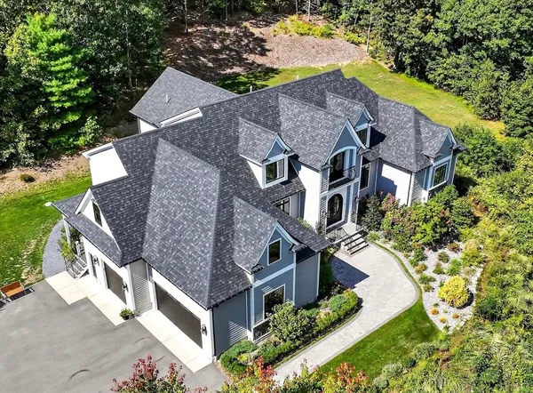 an aerial view of a house with a yard