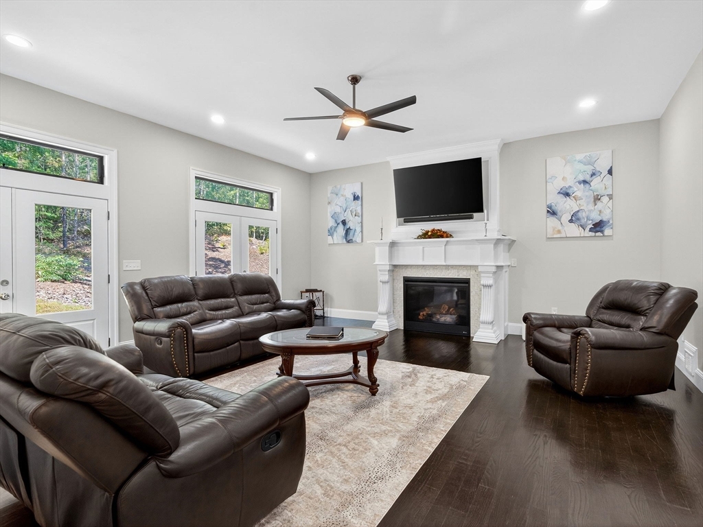 18 Keeney Pond Road Norfolk, MA 02056 - Photo 12 of 42 a living room with furniture a flat screen tv and a fireplace