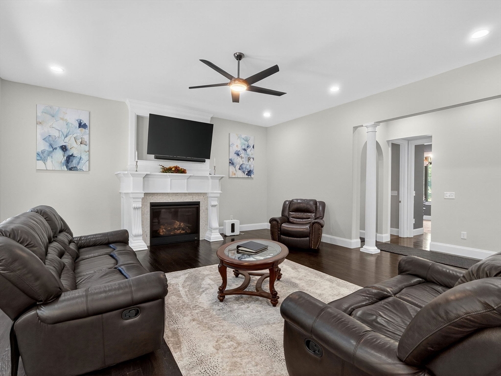 18 Keeney Pond Road Norfolk, MA 02056 - Photo 13 of 42 a living room with furniture a flat screen tv and a fireplace