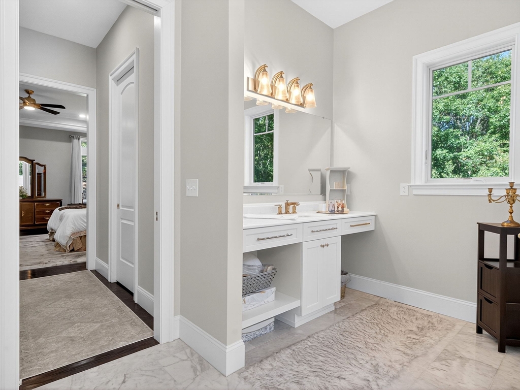 18 Keeney Pond Road Norfolk, MA 02056 - Photo 16 of 42 a en suite bathroom with a sink and a mirror