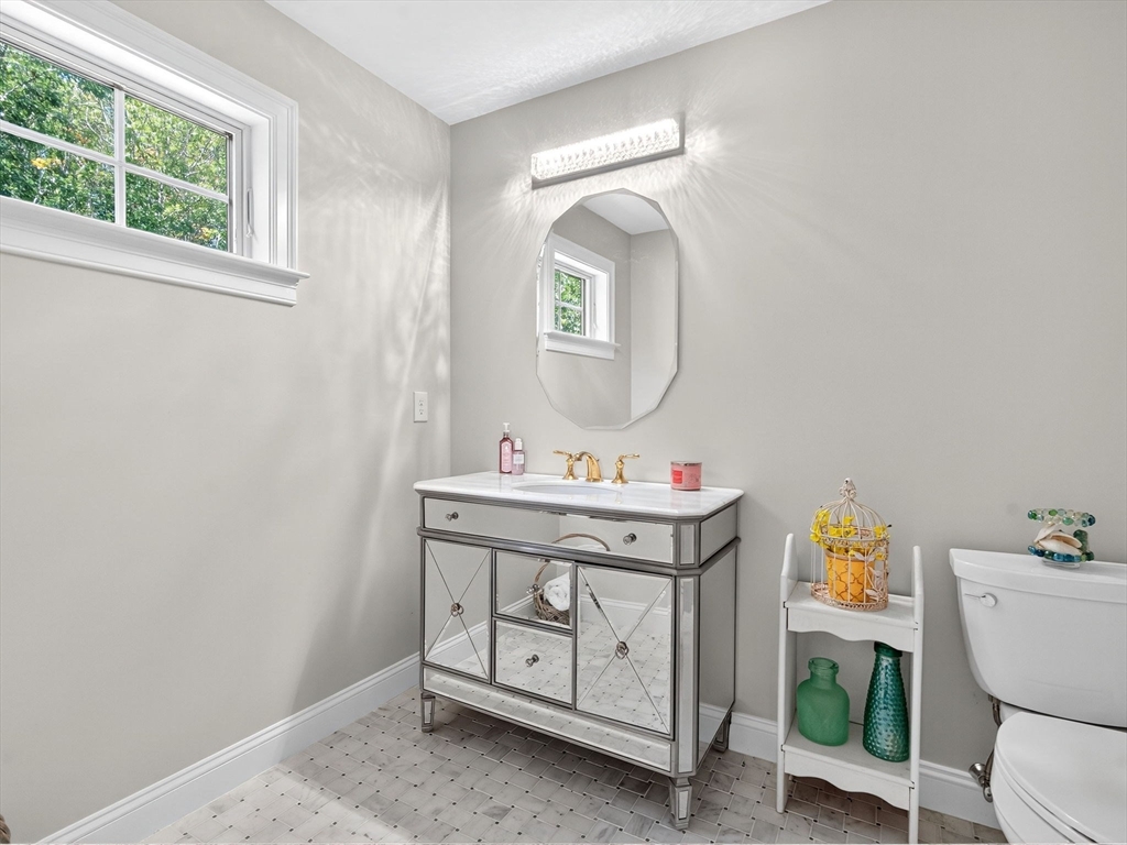 18 Keeney Pond Road Norfolk, MA 02056 - Photo 21 of 42 a bathroom with a toilet a sink and mirror