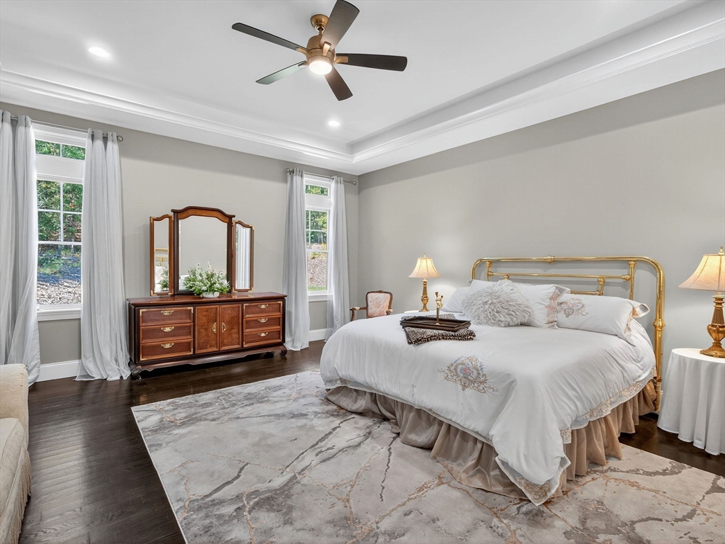 18 Keeney Pond Road Norfolk, MA 02056 - Photo 23 of 42 a bedroom with a bed and a large window with wooden floor