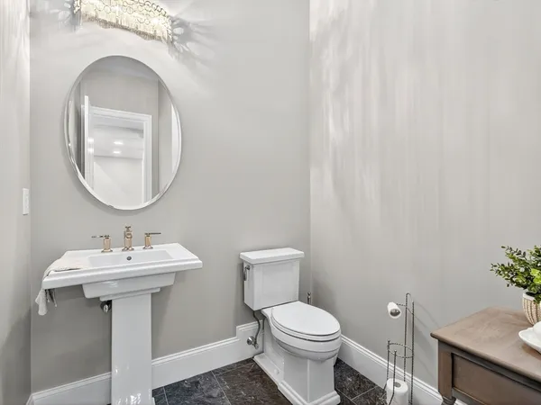 a bathroom with a sink mirror and toilet