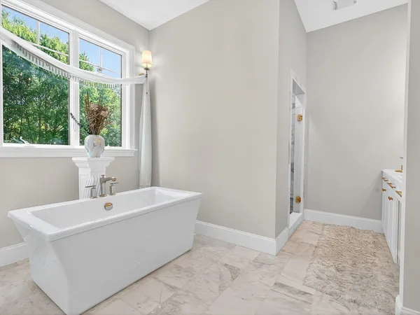 a bathroom with a sink a mirror and a bathtub