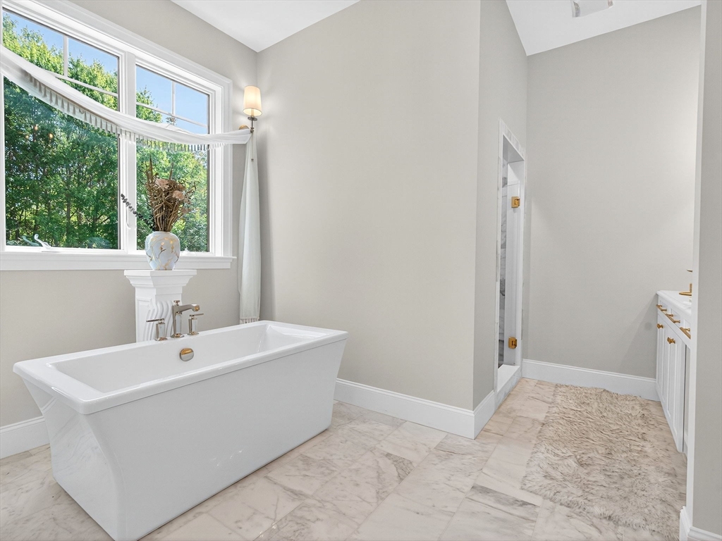 18 Keeney Pond Road Norfolk, MA 02056 - Photo 26 of 42 a bathroom with a sink a mirror and a bathtub