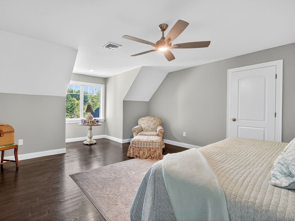 18 Keeney Pond Road Norfolk, MA 02056 - Photo 30 of 42 a bedroom with a bed and a chandelier