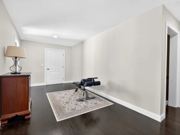a room with painting on the wall and a window