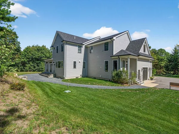 a front view of house with yard and green space